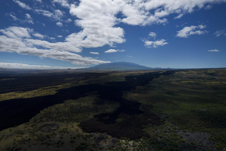 The sacred mountain of Mauna Kea on the Big Island of Hawaii, on Monday, July 17, 2023. Mauna Kea was born after a series of volcanic eruptions from the ocean floor created new land. Over a million years, it grew into the tallest mountain on earth when measured from its base in the Pacific Ocean to its summit soaring 13,796 feet ((4,205 meters) above sea level. (AP Photo/Jessie Wardarski)