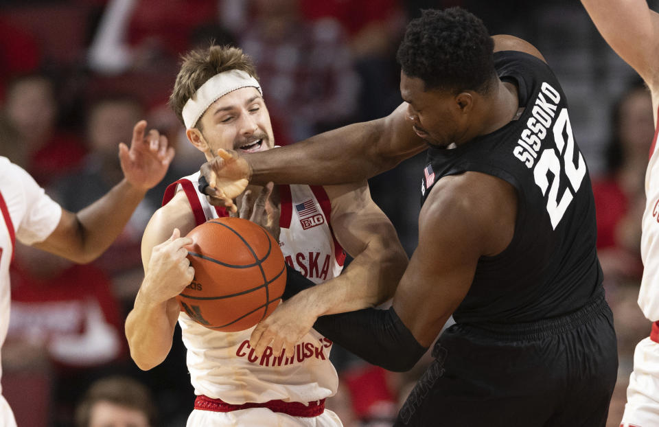 Nebraska's Sam Hoiberg, left, and Michigan State's Mady Sissoko (22) battle for a rebound during the first half of an NCAA college basketball game Sunday, Dec. 10, 2023, in Lincoln, Neb. (AP Photo/Rebecca S. Gratz)