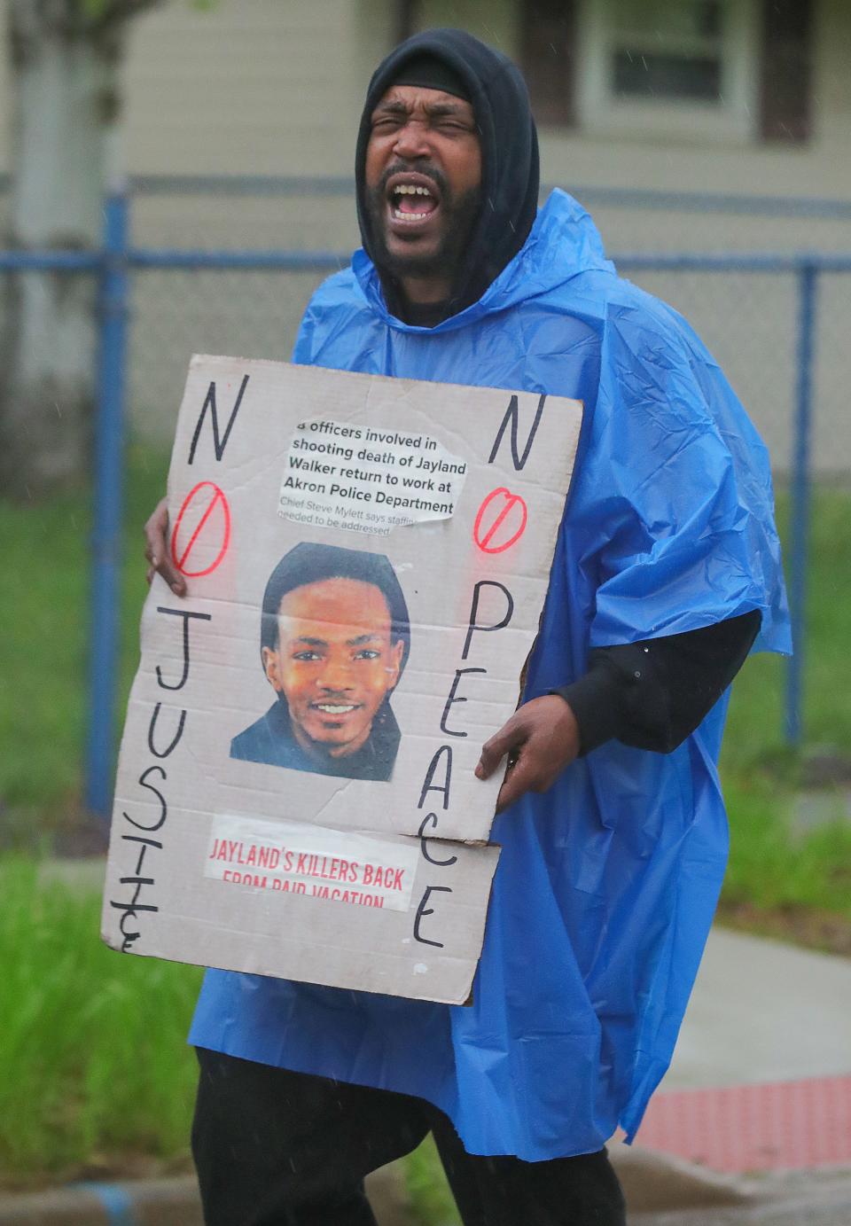 A protester marches along Fess Avenue in Akron for Jayland Walker on Friday.