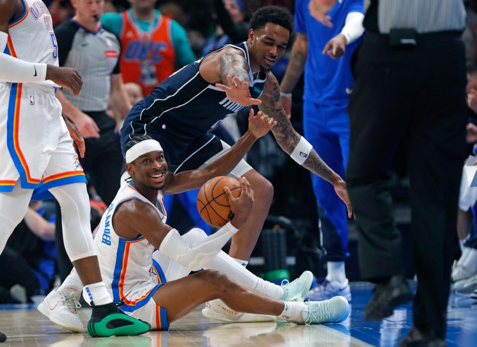 Oklahoma City Thunder's Shai Gilgeous-Alexander (2) reacts after a scramble for the ball with Dallas Mavericks' Derrick Jones Jr. (55) in the first half of the NBA basketball game between the Oklahoma City Thunder and Dallas Mavericks at Paycom Center in Oklahoma City, Thursday, March 14, 2024.