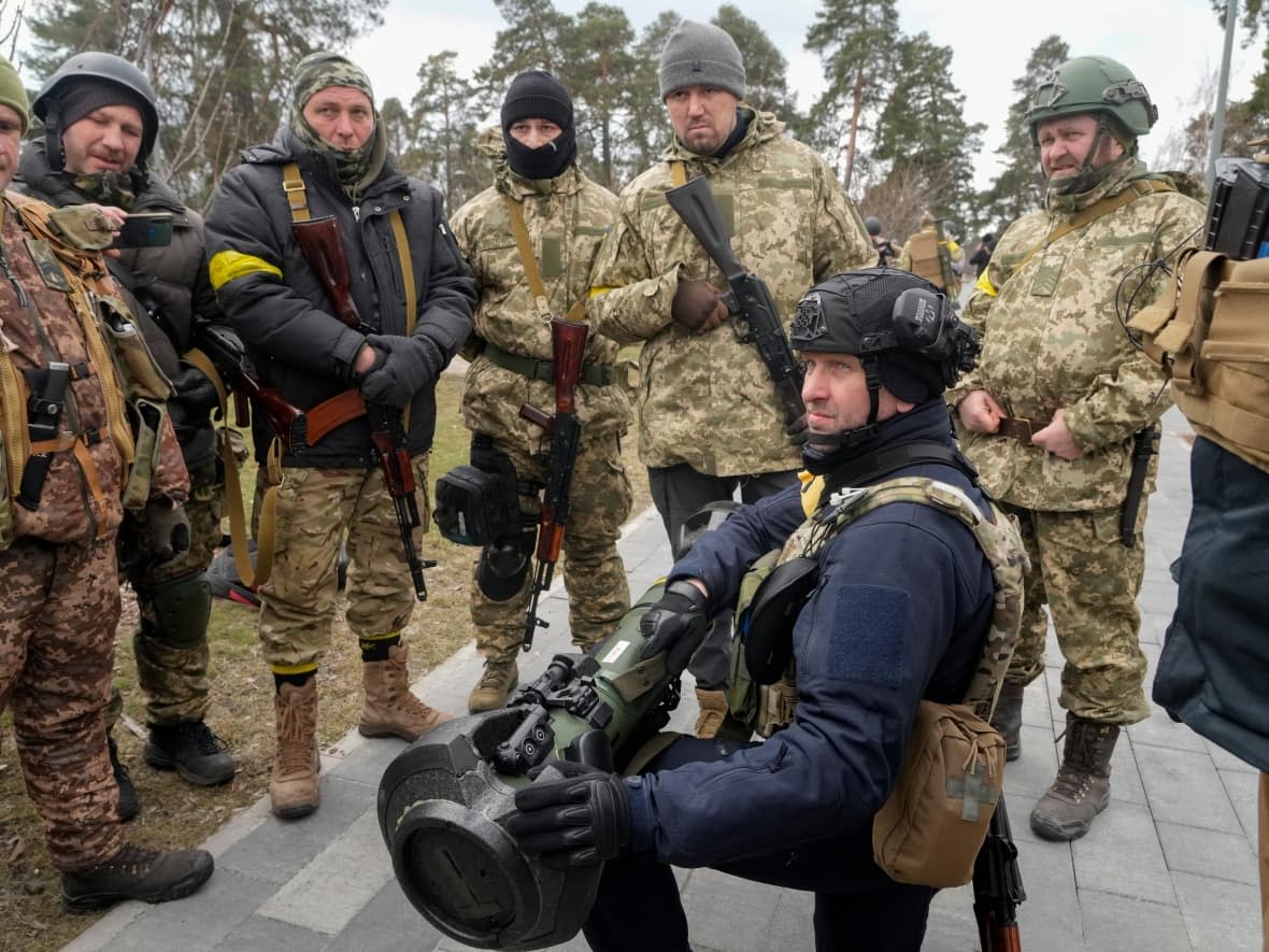 Ukrainian Territorial Defence Forces members train to use an NLAW anti-tank weapon on the outskirts of Kyiv on March 9, 2022. Russia says it will donate captured weapons like these to Moscow-backed militant groups. (Efrem Lukatsky/The Associated Press - image credit)