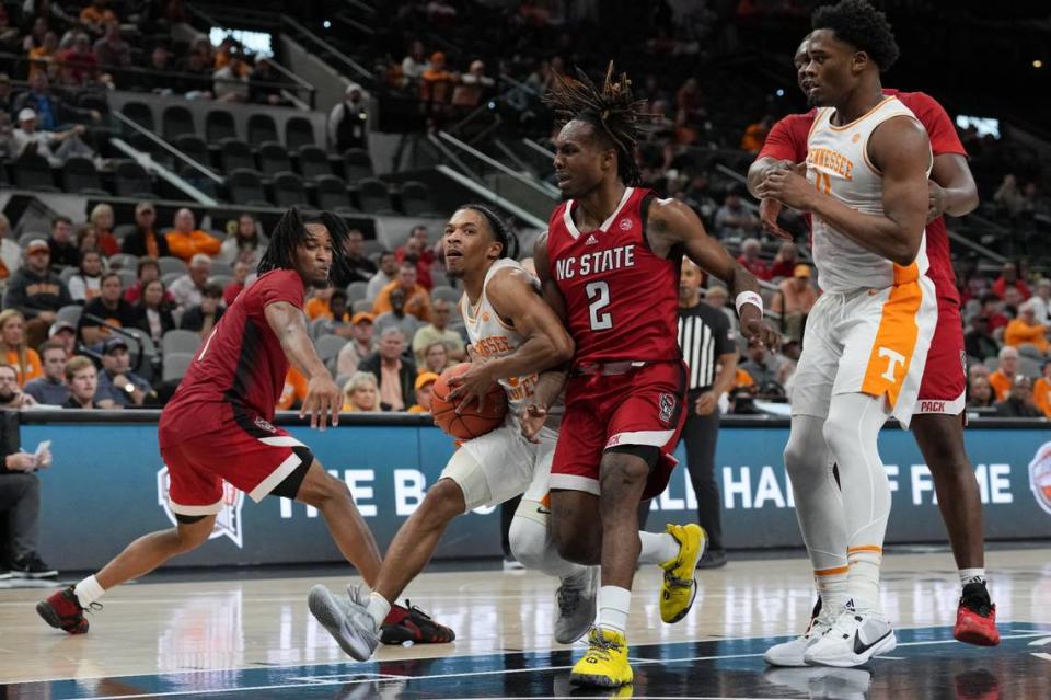 Dec 16, 2023; San Antonio, Texas, USA; Tennessee Volunteers guard Zakai Zeigler (5) drives in against North Carolina State Wolfpack guard Kam Woods (2) in the second half at the Frost Bank Center. Mandatory Credit: Daniel Dunn-USA TODAY Sports Daniel Dunn/Daniel Dunn-USA TODAY Sports