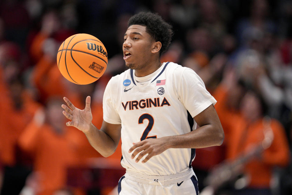 Virginia's Reece Beekman brings the ball up during the first half of the team's First Four college basketball game against Colorado State in the men's NCAA Tournament, Tuesday, March 19, 2024, in Dayton, Ohio. (AP Photo/Jeff Dean)