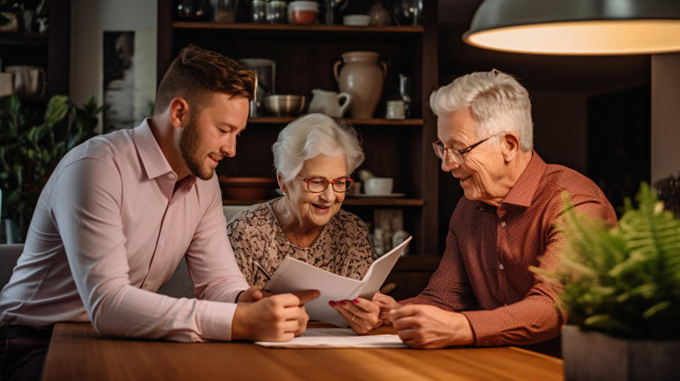 A financial advisor discussing retirement plans with an elderly couple in their home.