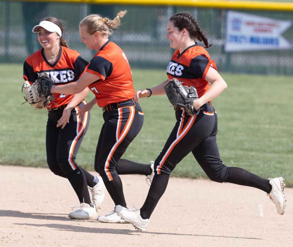 Marlington softball players celebrate a defensive play during their 1-0 win over Aurora in a Division II district final, Thursday, May 18, 2023, in Jefferson.