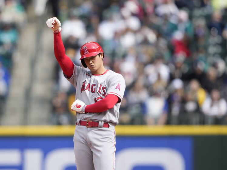 Los Angeles Angels' Shohei Ohtani gestures on the base path against the Seattle Mariners.