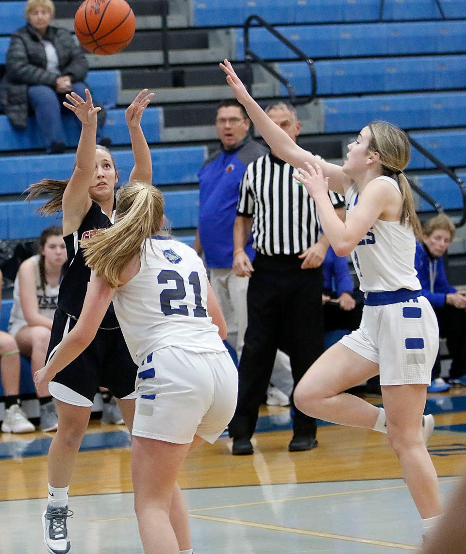 Crestview High School's Anna McFarland (15) puts up shot over Northwestern High School's Lynzi Smith (21) and Caydance Scale (4) during high school girls basketball action Tuesday, Jan. 4, 2021 at Northwestern High School. TOM E. PUSKAR/TIMES-GAZETTE.COM