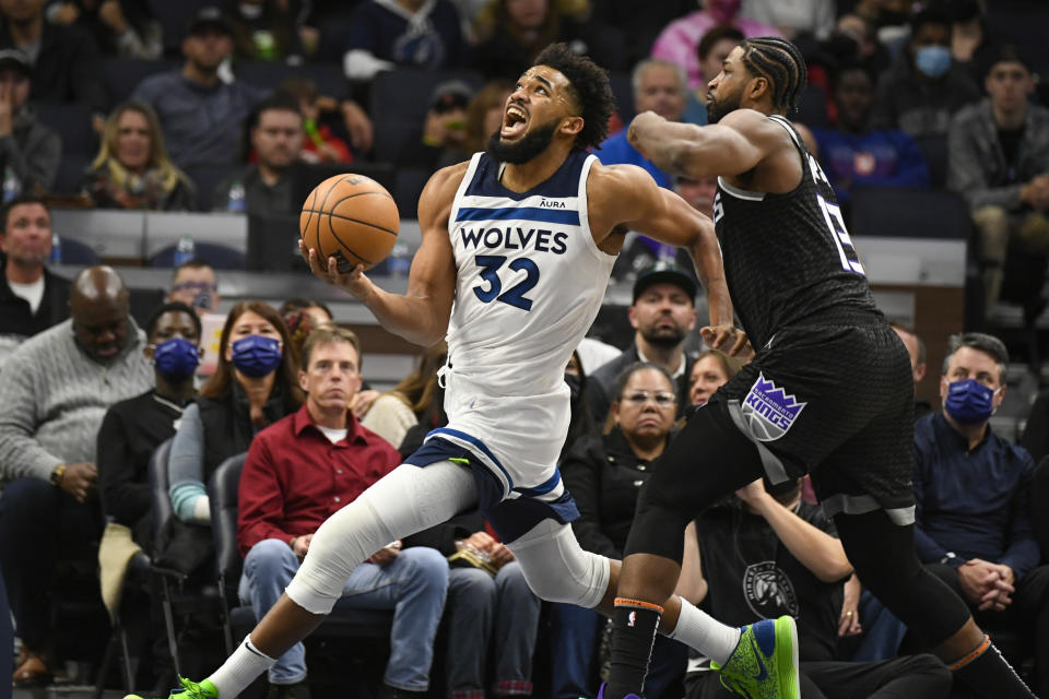 Minnesota Timberwolves center Karl-Anthony Towns (32) drives to the basket past Sacramento Kings center Tristan Thompson during the second half of an NBA basketball game Wednesday, Nov. 17, 2021, in Minneapolis. (AP Photo/Craig Lassig)