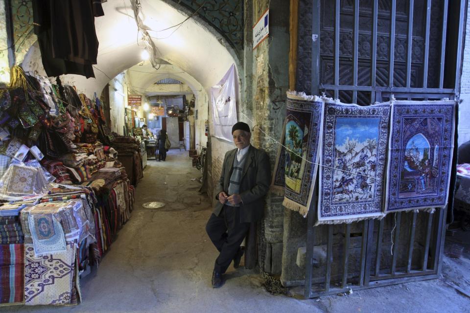 FILE - In this April 7, 2011 file photo, an Iranian vendor stands in front of his goods at Qeisariyyeh old bazaar, in Imam Square in the city of Isfahan, Iran. The ancient and rich cultural landscape of Iran has become a potential U.S. military target as Washington and Tehran lob threats and take high-stakes steps toward a possible open conflict. President Donald Trump tweeted Saturday, Jan. 4, 2020, that if Iran targets any American assets to avenge the killing of a top Iranian general, the U.S. has 52 Iranian sites it will hit, including ones “important to Iran & Iranian culture." (AP Photo/Vahid Salemi, File)
