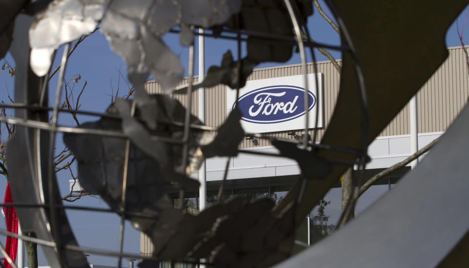 The Ford logo is seen through a sculpture of a globe outside of the Ford plant in Genk, Belgium on Tuesday, Oct. 23, 2012. The fate of the under-utilized Ford plant in Belgium could become known as early as Wednesday following an emergency meeting between the automaker and unions. The severe sales slump, sales in Europe are the lowest since the early 1990's, has led to many factories operating far below their capacity, resulting in high incentive costs and huge losses affecting all automakers. (AP Photo/Virginia Mayo)