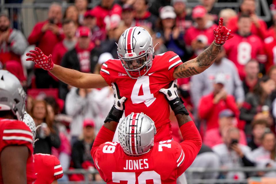 Ohio State receiver Julian Fleming celebrates with tackle Dawand Jones after scoring a touchdown against Rutgers on Saturday.