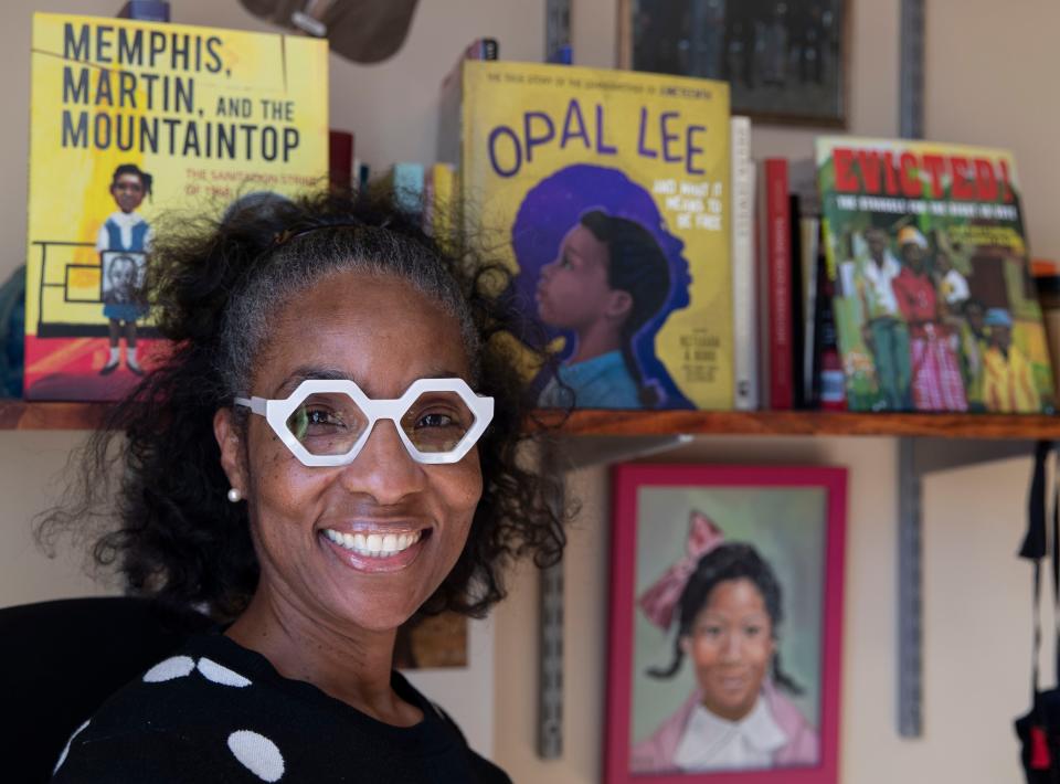 Alice Faye Duncan poses with her books Wednesday, Feb. 9, 2022, at her home in Memphis.