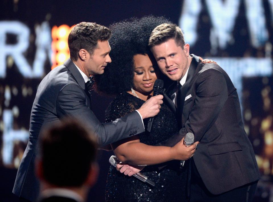 American Idol Season 15 winner Trent Harmon, right, and finalist La'Porsha Renae, center, are joined by host Ryan Seacrest, left, on Fox's "American Idol" in 2016.