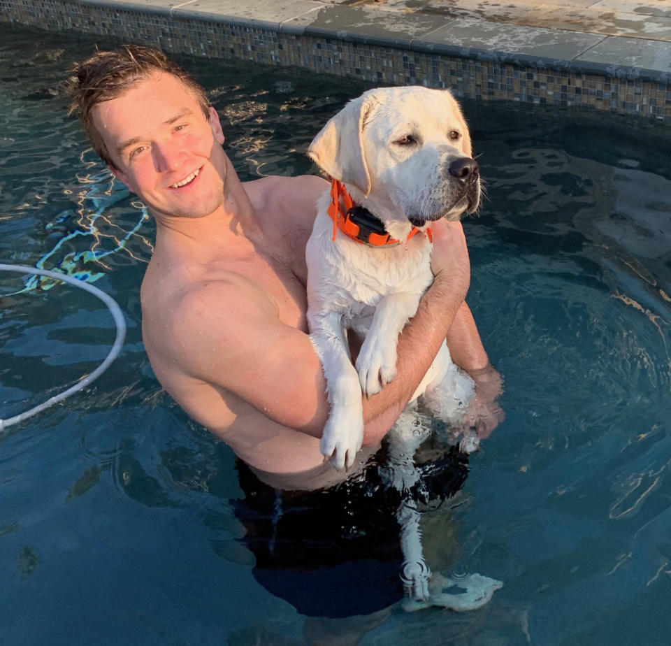 Sam Ehlinger plays with his dog, Spur, in the Ehlinger family pool. (Photo credit: Ehlinger family)