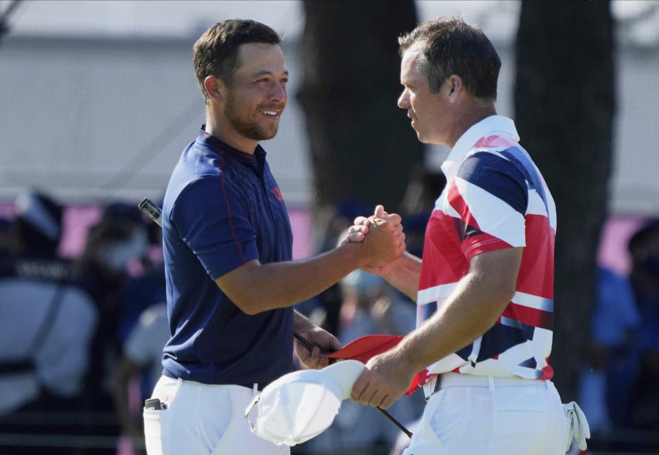 CORRECTS LAST NAME TO SCHAUFFELE FROM SHAUFFELE - Xander Schauffele of the United States, left, is congratulated by Paul Casey of Britain after winning gold in the men's golf event at the 2020 Summer Olympics on Sunday, Aug. 1, 2021, in Kawagoe, Japan. (AP Photo/Andy Wong)