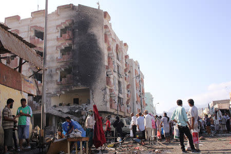 People gather at the site of a car bomb attack outside the Finance Ministry offices in the southern port city of Aden, Yemen November 29, 2017. REUTERS/Fawaz Salman