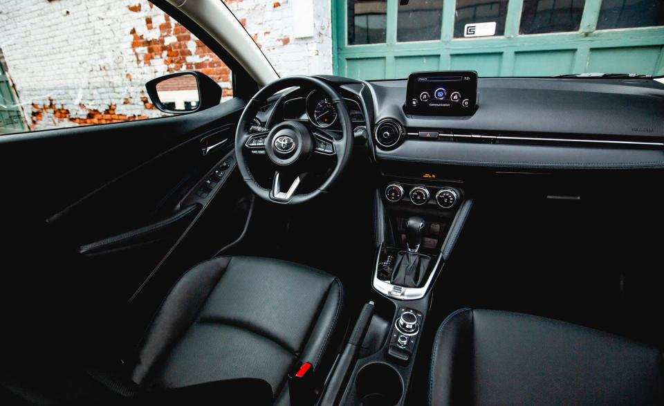 <p>Blue stitching and soft-touch materials make the Yaris's cabin feel more befitting a $20,000 car.</p>