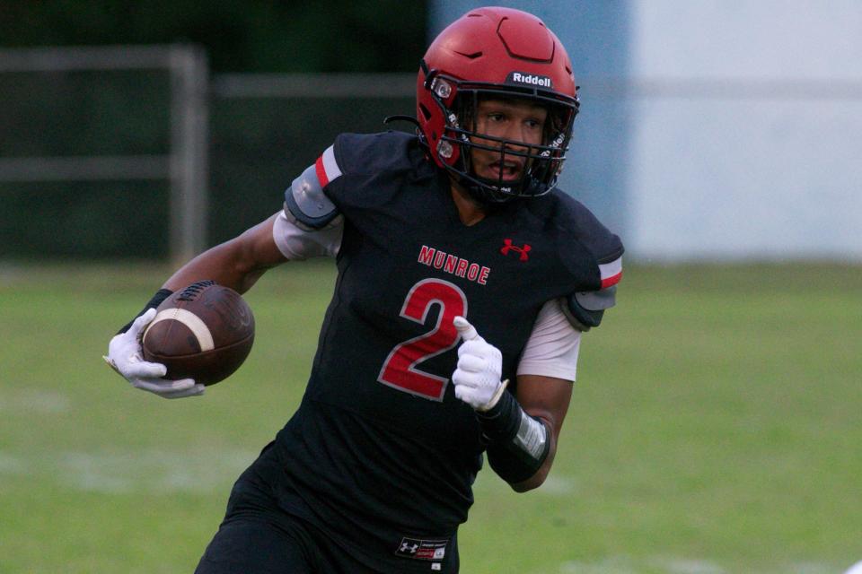 Munroe senior wide receiver Ahmari Borden (2) rushes the ball upfield in a game against NEFI on Aug. 18, 2022, at Corry Field. The Bobcats won, 40-0.