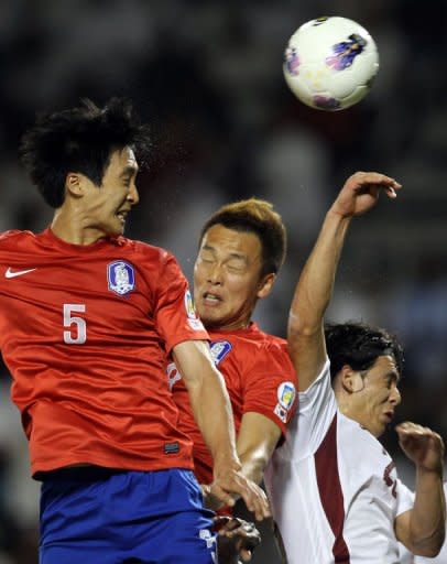 South Korea's Kwak Tae Hwi (L) heads the ball to score against Qatar during their group B 2014 World Cup Asian qualifying football match in Doha. South Korea won 4-1