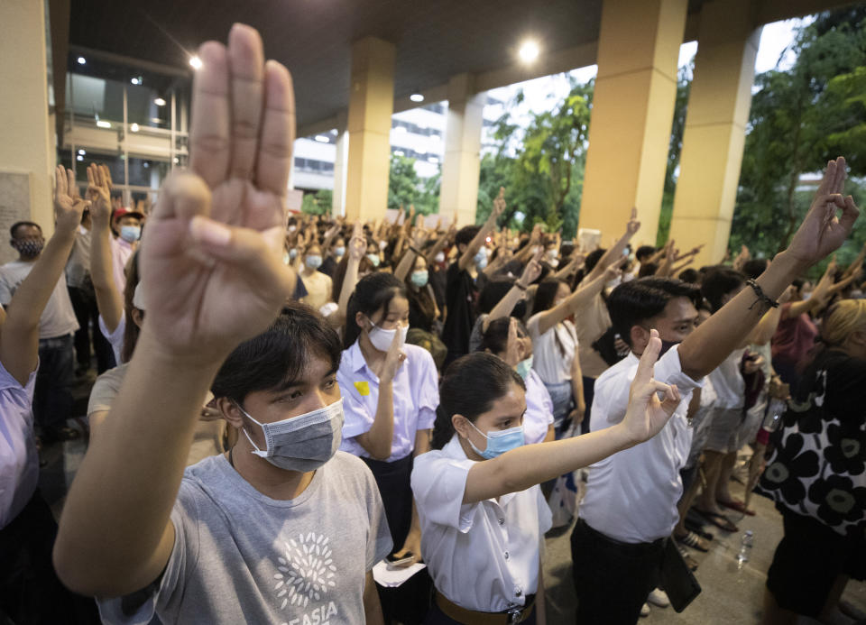 Pro-democracy students raise a three-finger symbol of resistance salute during a protest at Chulalongkorn University in Bangkok, Thailand, Friday, Aug, 14, 2020. Student activists at Thailand's most prestigious university defied a ban by college administrators to stage an anti-government rally Friday, even as a prominent protest leader was arrested elsewhere for his involvement in a previous demonstration. (AP Photo/Sakchai Lalit)