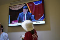 A woman watches the House Civil Justice Subcommittee meeting on a monitor in the hall after the audience was removed by the Republican chairman during a special session of the state legislature on public safety Tuesday, Aug. 22, 2023, in Nashville, Tenn. (AP Photo/George Walker IV)