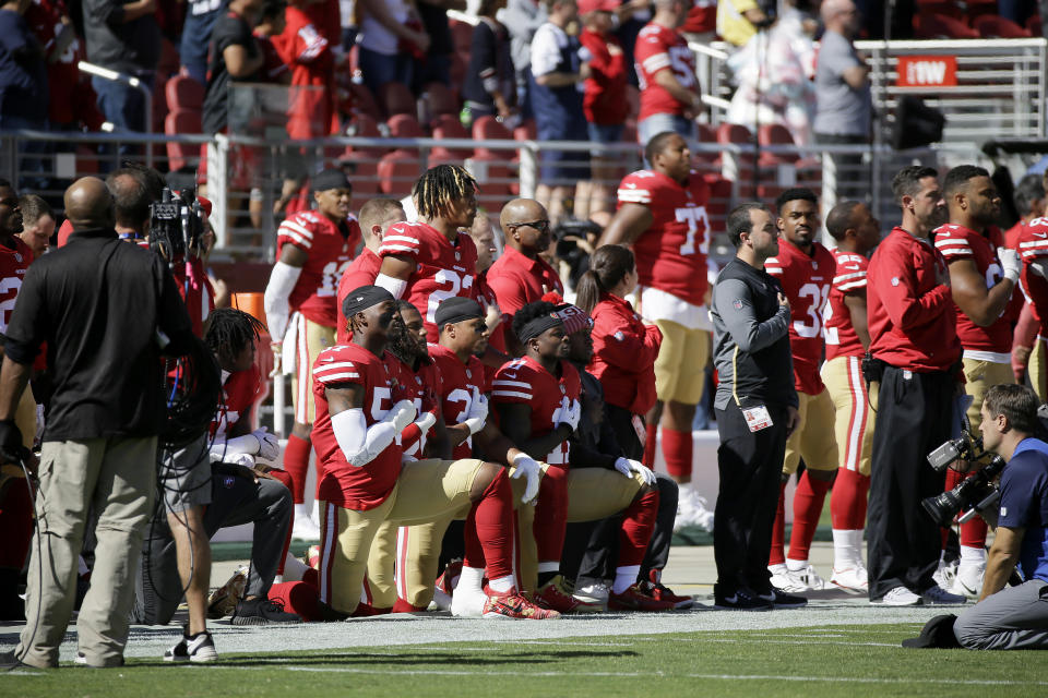 San Francisco 49ers players kneel during the performance of the national anthem on Sunday. (AP)