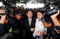 North Korean Ambassador to Malaysia Kang Chol (C), who was expelled from Malaysia, is escorted as he arrives at Kuala Lumpur international airport in Sepang, Malaysia March 6, 2017. REUTERS/Lai Seng Sin