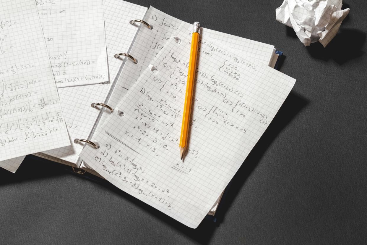Mathematical equations written in a notebook