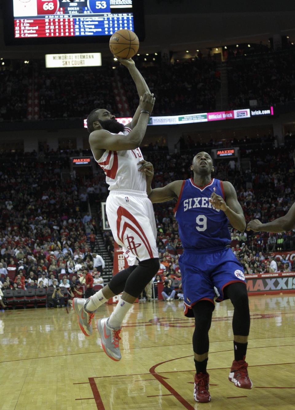 Houston Rockets' James Harden (13) shoots over Philadelphia 76ers' James Anderson (9) during the second half of an NBA basketball game on Thursday, March 27, 2014, in Houston. Houston won 120-98. (AP Photo/Bob Levey)