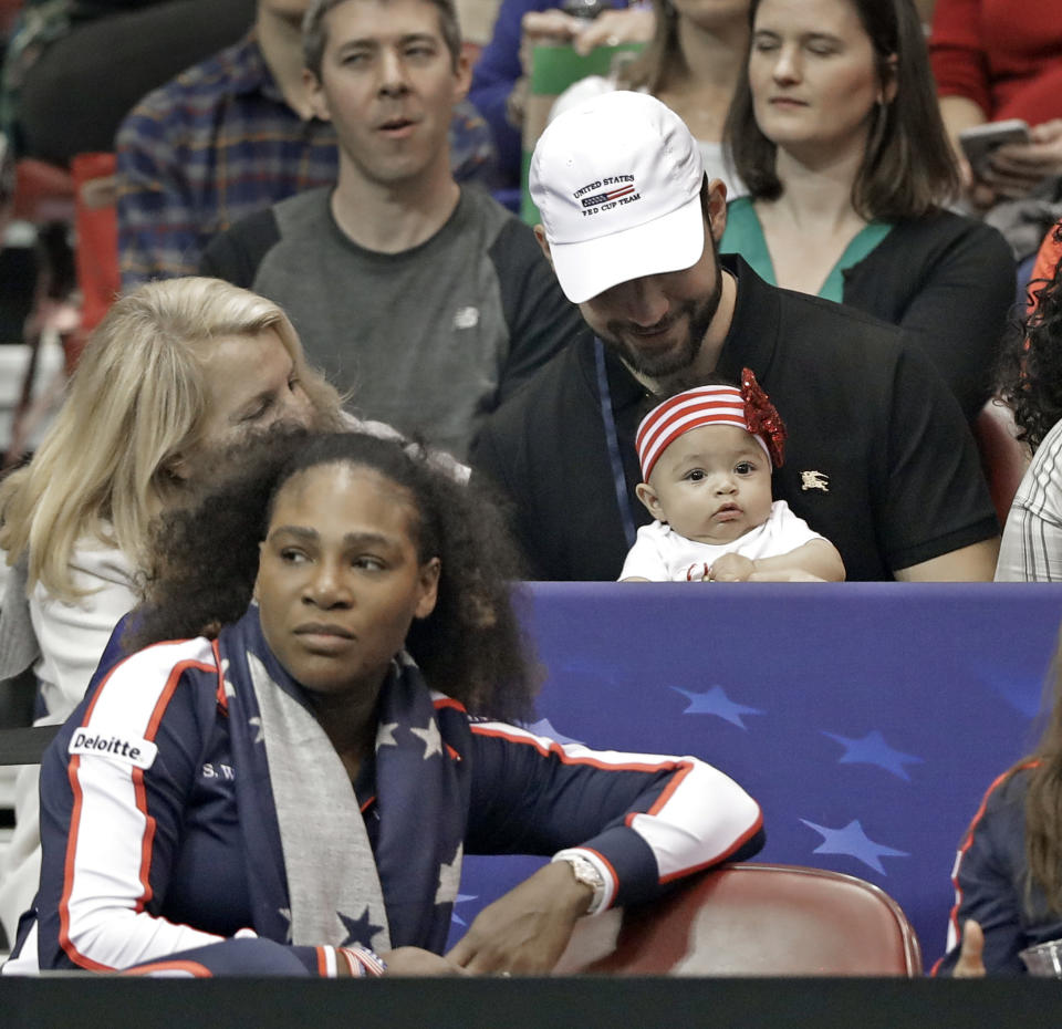 Serena Williams, left, watches the action with husband Alexis Ohanian, top right, and their baby, Alexis Olympia Ohanian Jr. during a match in the first round of Fed Cup tennis competition in Asheville, N.C., in February. (AP)