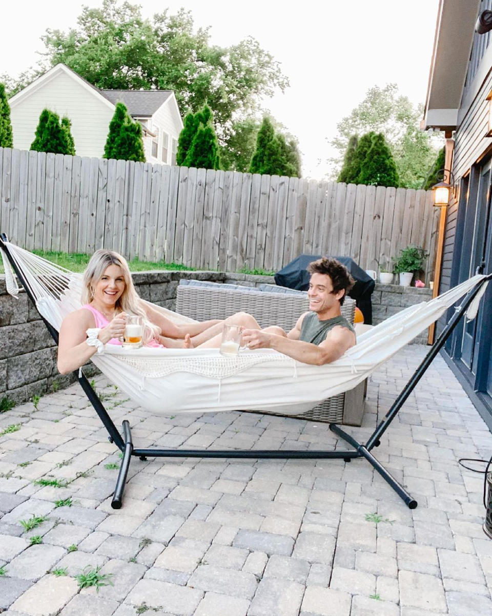 <p>"Last night after the kids went to bed Kevin and I grabbed a few beers and relaxed in our hammock while watching fire flies," the former <em>Bachelorette</em> <a href="https://www.instagram.com/p/CQJJmkSH71m/" rel="nofollow noopener" target="_blank" data-ylk="slk:wrote;elm:context_link;itc:0;sec:content-canvas" class="link ">wrote</a> of the new backyard accessory she got her husband for Father's Day that now hangs in their Nashville backyard. "It was perfect."</p>