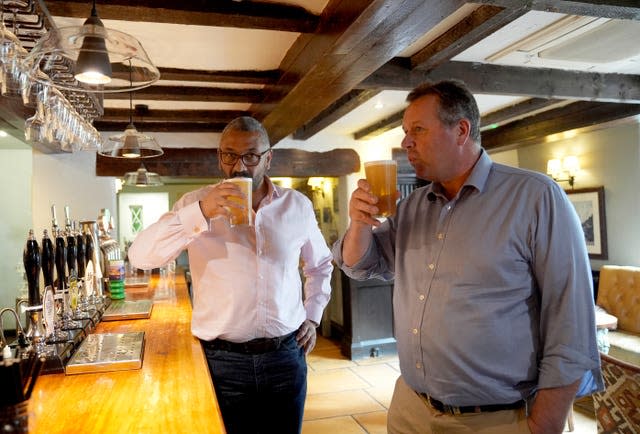 Home Secretary James Cleverly and Mark Spencer drink a pint of ale during a visit to The Hutt in Nottingham