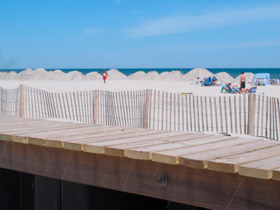 Piles of sand and a bulkhead recently built in North Wildwood, N.J. ON June 8, 2020, where the state Department of Environmental Protection says the city destroyed sand dunes without permission. The city acknowledges it built the wall without a permit, but says it had to because of erosion and damage to the beachfront that could not wait.<span class="copyright">Wayne Parry—AP</span>