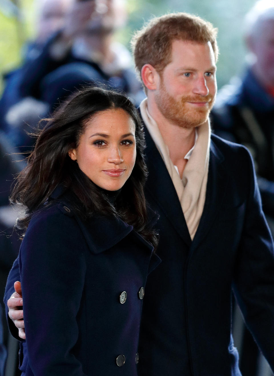Prince Harry and Meghan Markle on an official visit wearing black coats