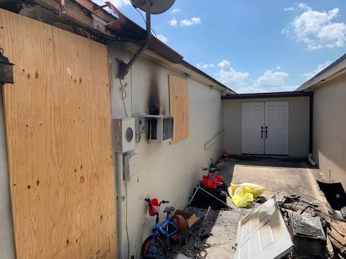 The boarded up door, window and the air conditioner to the garage efficiency apartment at 15856 SW 143rd Ct., where Kenneth Pirraglia in a fire Tuesday.