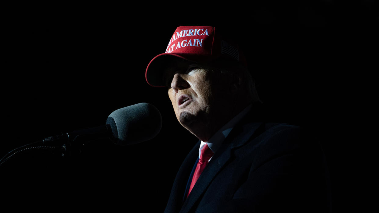 Former President Donald Trump wearing a Make America Great Again cap speaks at a rally in Georgia.