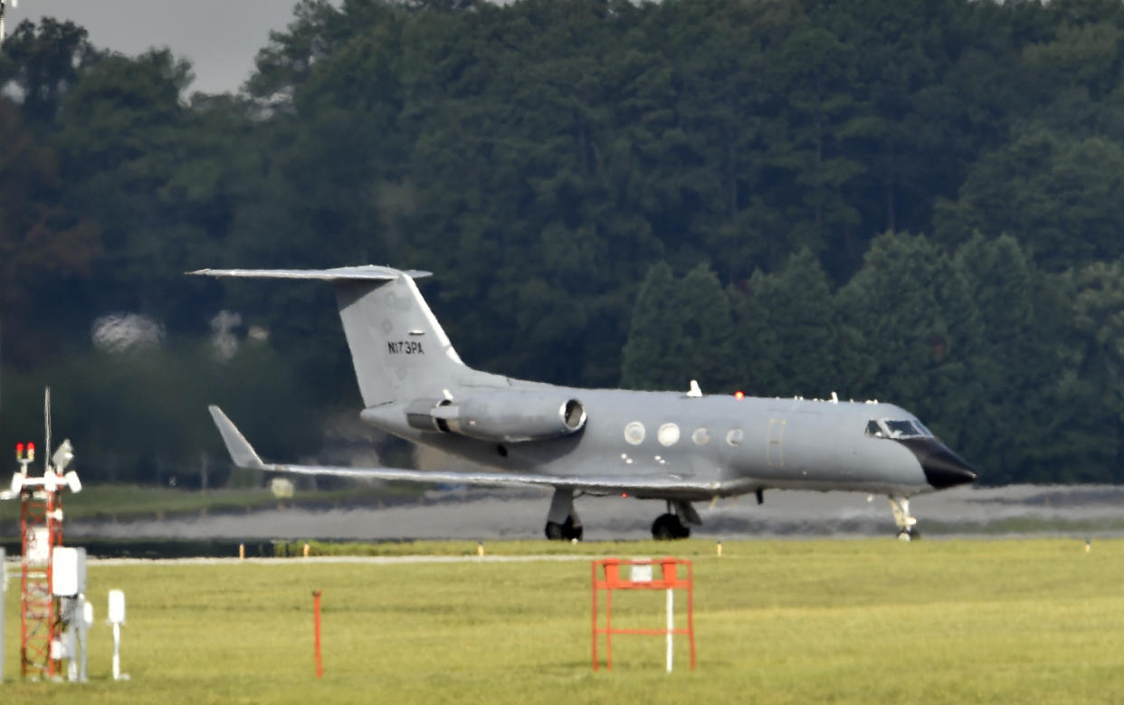 An airplane transporting a doctor infected with the deadly Ebola in West Africa lands near Atlanta on Tuesday.  (AP Photo/David Tulis)