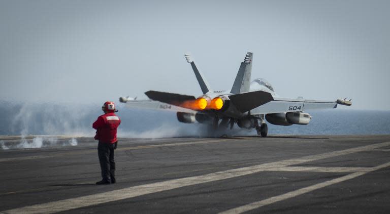 An EA-18G launches from the flight deck of the aircraft carrier USS Carl Vinson on March 19, 2015 as it takes part in strike operations in Iraq and Syria