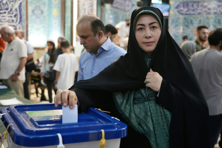 An Iranian woman casts her vote at a polling station in Tehran during the Islamic republic's presidential election (RAHEB HOMAVANDI)