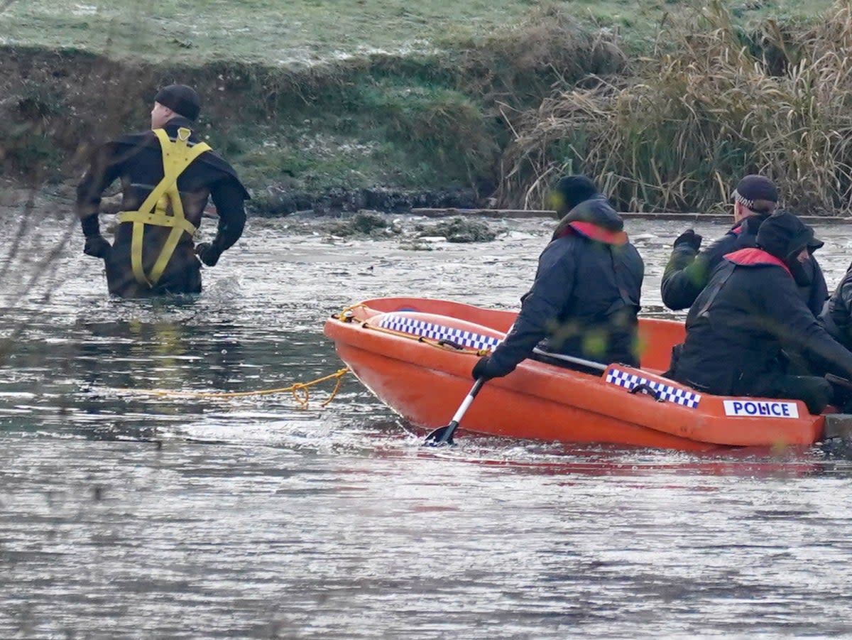 Police break the ice on the lake at Babbs Mill Park in Kingshurst, after the deaths of four boys (PA)