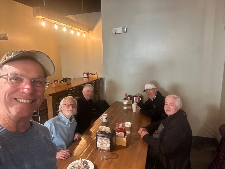 Dennis Gillan, left, formed the "Camo Hat Club" for men to talk about their mental health in Greenville, South Carolina. The group has met once a month for breakfast for the last five years.