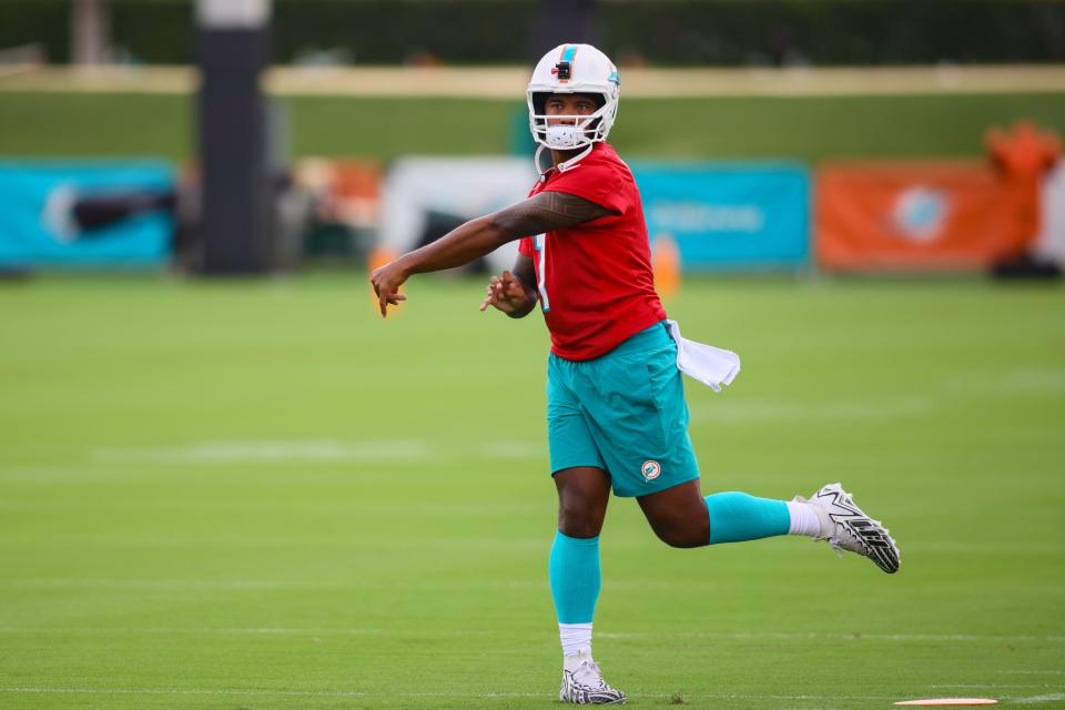 Jul 24, 2024; Miami Gardens, FL, USA; Miami Dolphins quarterback Tua Tagovailoa (1) throws the football during training camp at Baptist Health Training Complex. Mandatory Credit: Sam Navarro-USA TODAY Sports