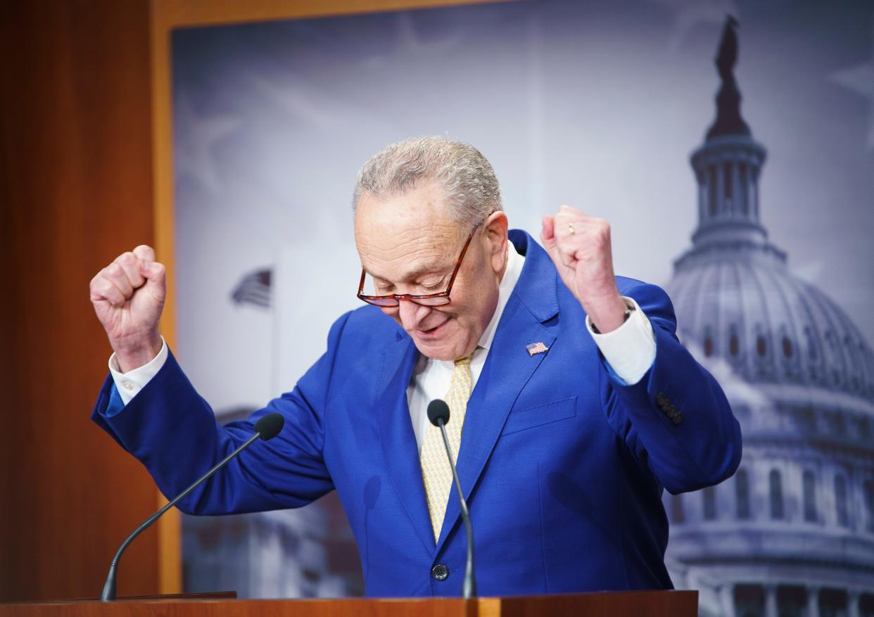 Senate Majority Leader Chuck Schumer gives a celebratory double fist pump as he begins a press conference following the Senate vote early Tuesday morning passing a $95 billion emergency defense spending bill, including $60 billion for Ukraine, on Tuesday, Feb. 13, 2024