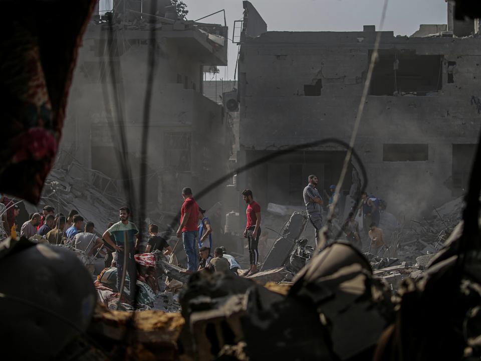 Palestinians search for bodies and survivors among the rubble (EPA)