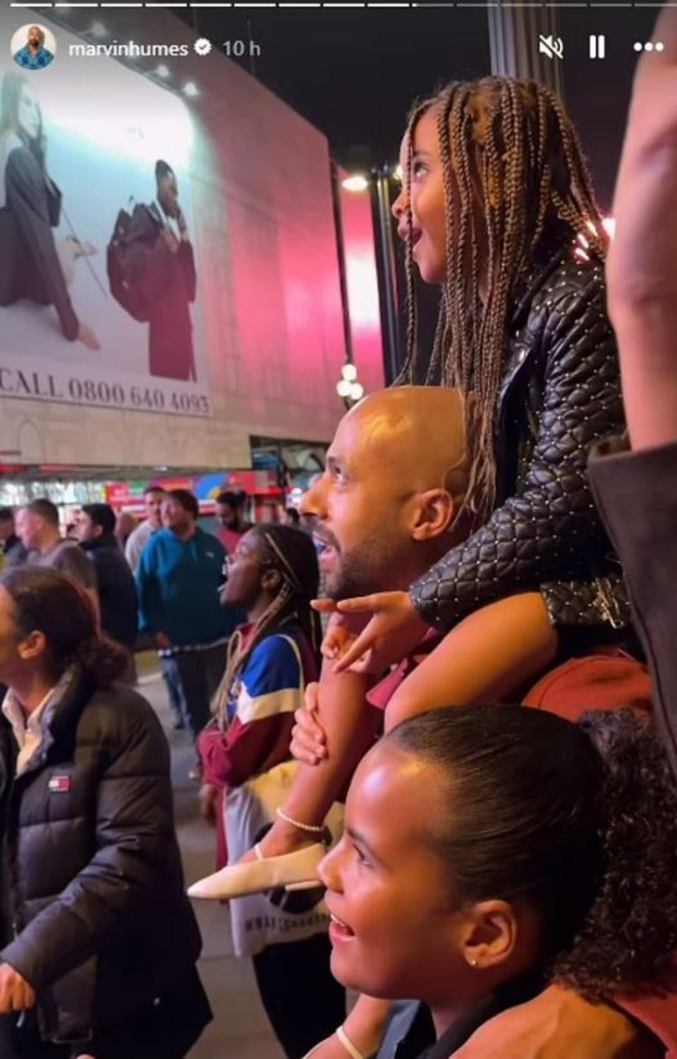 The girls looked delighted as they watched their mum on the billboard screens in Piccadilly Circus (Instagram @marvinhumes)