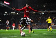 Bayer Leverkusen's Giulio Donati (bottom) and Manchester United's Robin van Persie battle for the ball