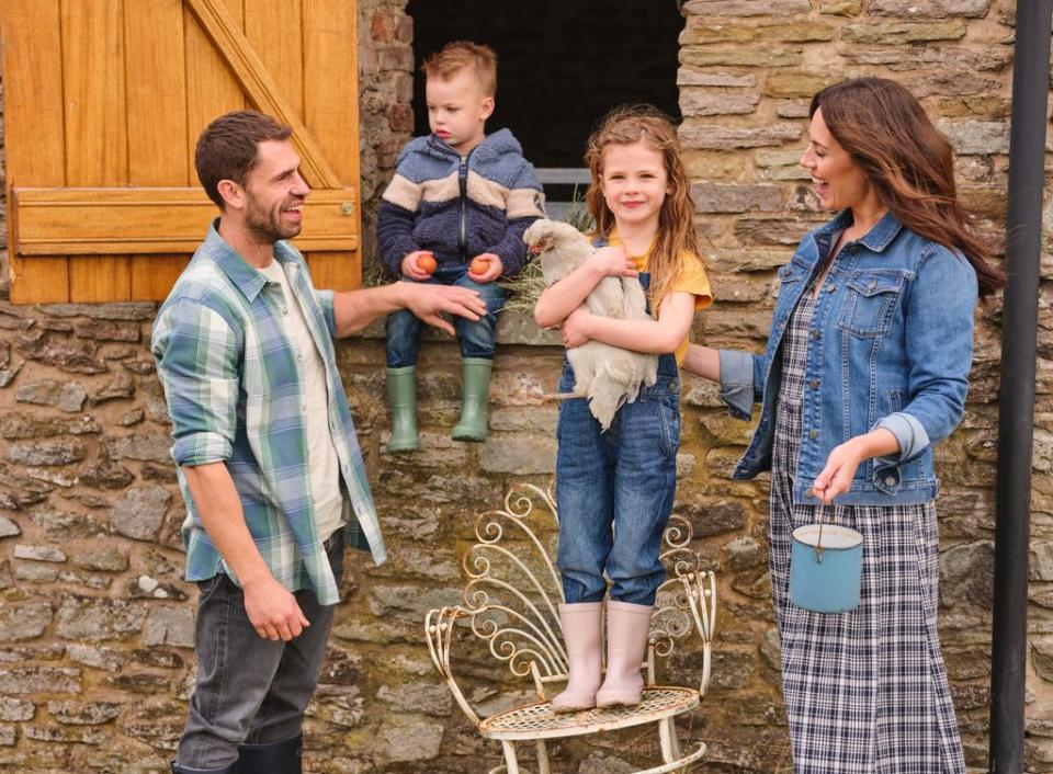 Kelvin and Liz Fletcher with their kids on the farm