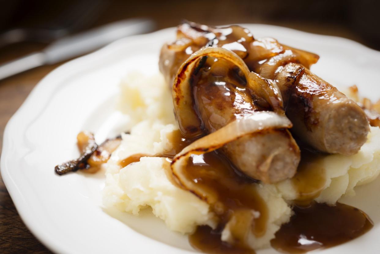 Mashed Potatoes with Sausages and caramelised onions with gravy. Traditional British food, commonly known as Bangers and Mash.