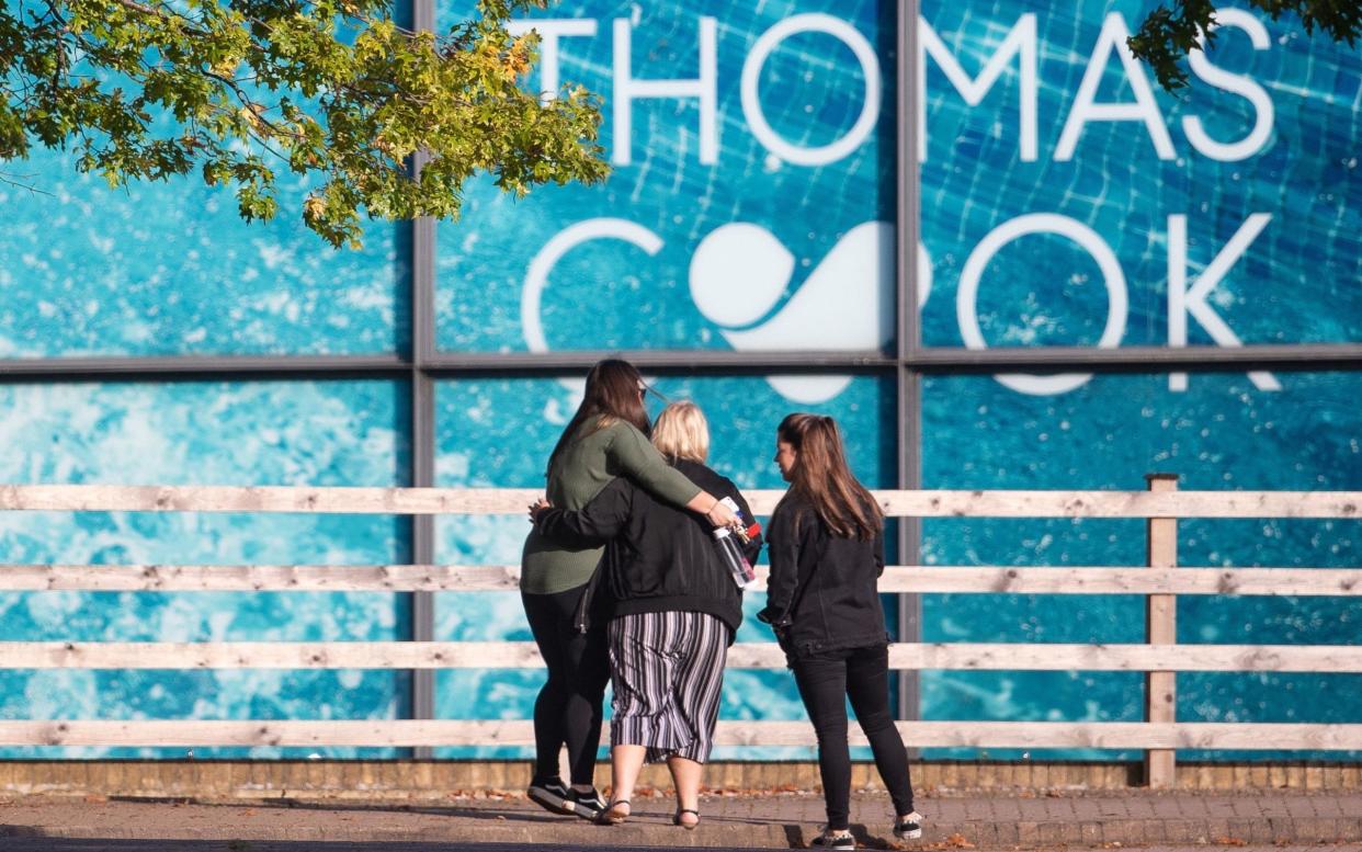 End of an era: People comfort each other outside the Peterborough headquarters of collapsed tour operator Thomas Cook - PA