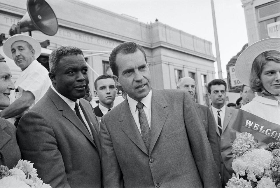 In this Oct. 4, 1960 photograph, baseball legend Jackie Robinson stands with then-Vice President Richard M. Nixon (right) during a campaign stop in New Jersey. <a href="https://www.gettyimages.com/detail/news-photo/vice-president-richard-m-nixon-chats-with-former-baseball-news-photo/514900632?adppopup=true" rel="nofollow noopener" target="_blank" data-ylk="slk:Bettmann/GettyImages;elm:context_link;itc:0" class="link ">Bettmann/GettyImages</a>